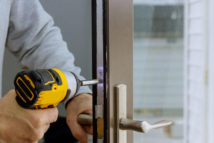 Man attaching the handles to the door