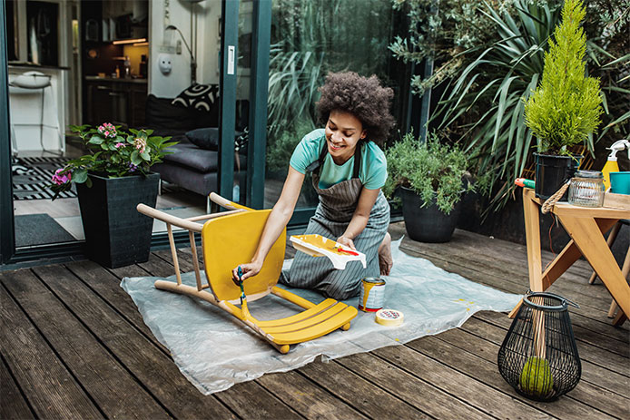 Woman painting chair