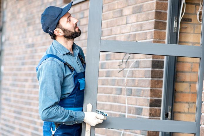 Man placing door into frame